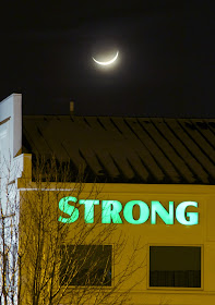 crescent moon over building roof