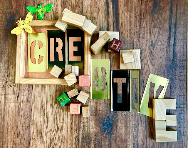 "Cre8tive" spelled out in blocks and stencils