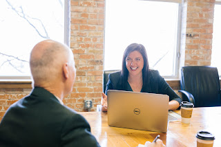 Two business people meeting | Collection agency Muskegon