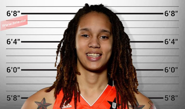 Brittney Griner posing in front of a height chart background