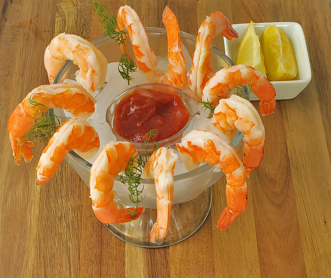 shrimp cocktail in a glass with ice and cocktail sauce