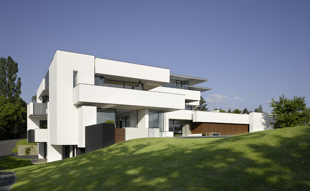 Photo of an amazing home as seen from the grass in the backyard