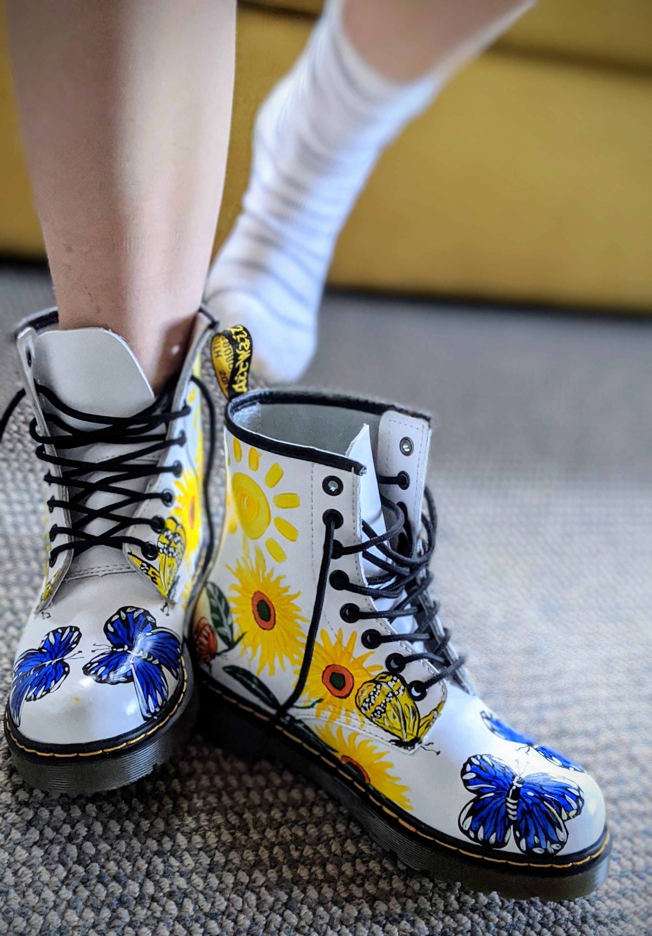 Woman putting on her coloured Doc Martin boots