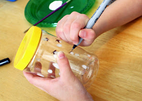 Afterward, she drew antennae and wings onto the "fireflies" on the outside of the jar with a fine-tip black Sharpie marker.