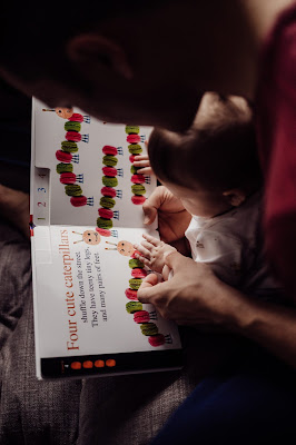 In home lifestyle Family imagery of Father and Daughter reading book together photogrpahed by Morning Owl Fine Art Photography San Diego. 