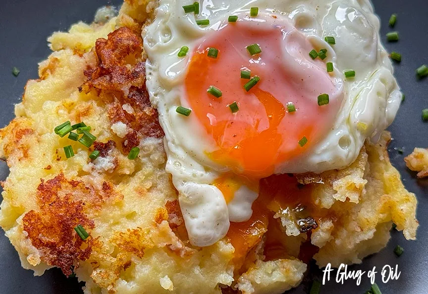 Fried mashed potatoes with a fried egg.