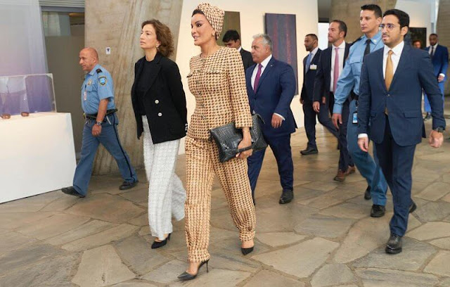 Princess Caroline wore a white tweed jacket by Chanel. Maria Teresa wore Maison Rabih Kayrouz gray asymmetric outfit