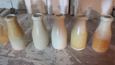 Antique ceramic milk bottles, cream city brick ceramic glaze.