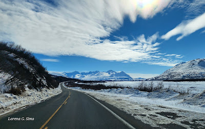 Beautiful sky, winding road, snow, mountains