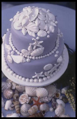 Delicate lilac blue wedding cake with pure white sugar sea shells