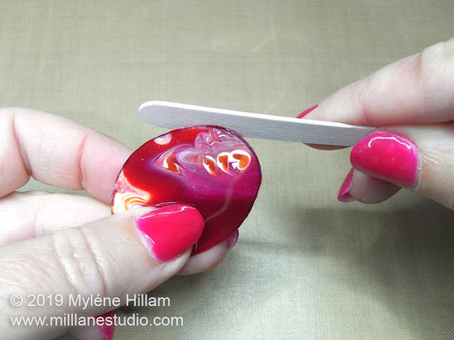 Filing the edges with an emery board.