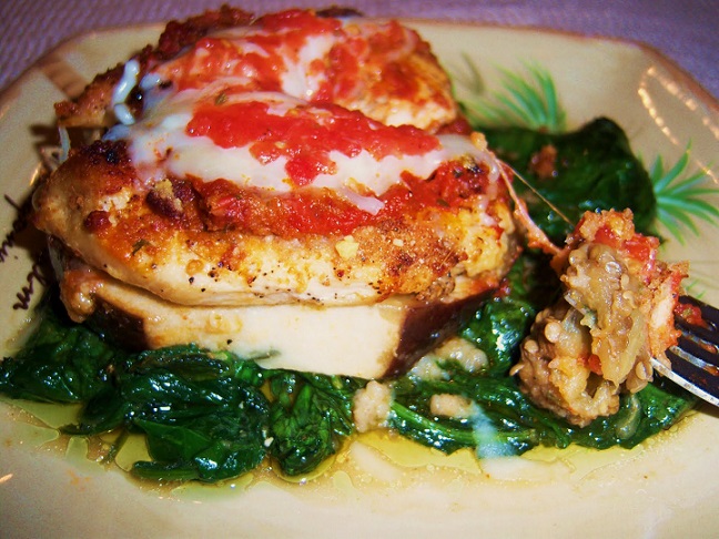 stacked eggplant with cheese, spinach and tomato