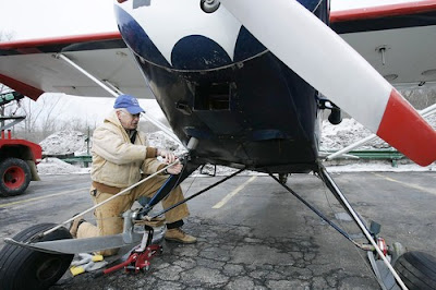 Robert Kadera removing the ski landing gear from his 1949 Piper Clipper