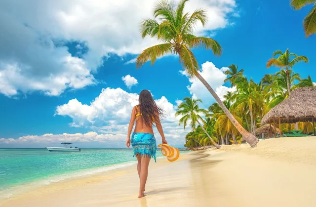 A girl walking on jamaica beach