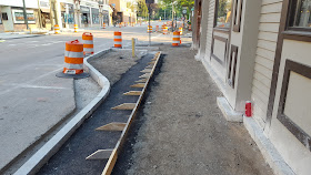 sidewalk work continues in front of the Berry Building