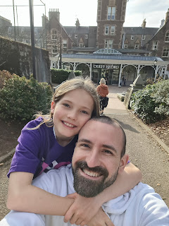 Father and daughter cuddling and smiling at Crieff hydro