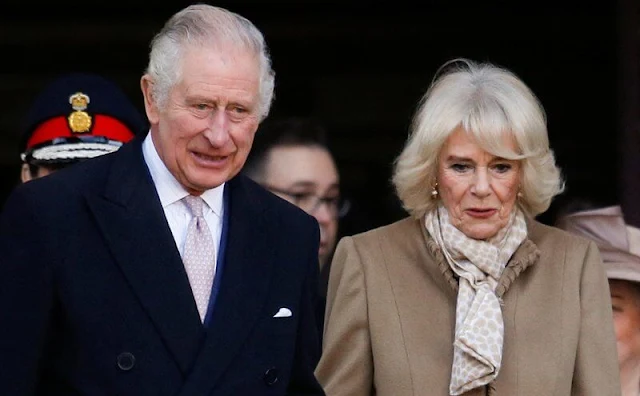 Queen Camilla wore a beige midi coat and floral print dress. Beige suede boots. The Norbrook Community Centre in Wythenshawe