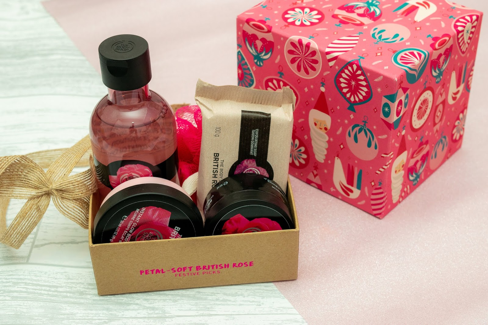 A selection of soap, scrubs, shower gels in pink packaging.