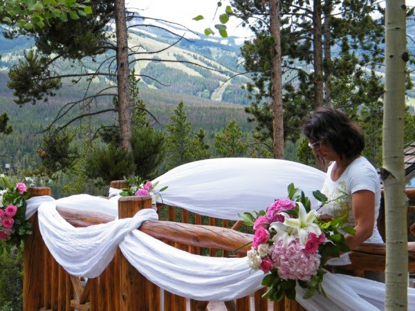 Dina puts the final touches on the outside deck flowers and decor