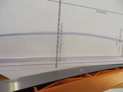 Paper trimmer blade intersecting with the cutting line on the pattern page.