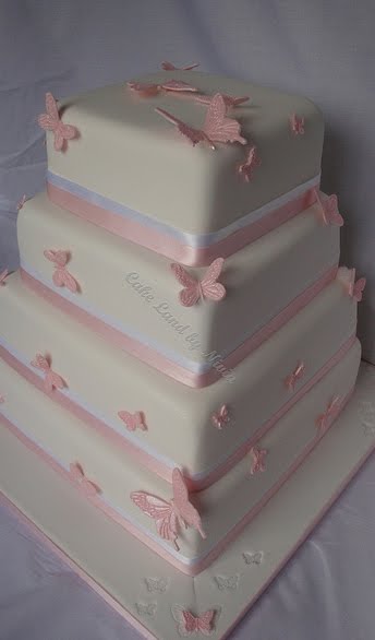 Four tier white square wedding cake A different take on the pink butterfly