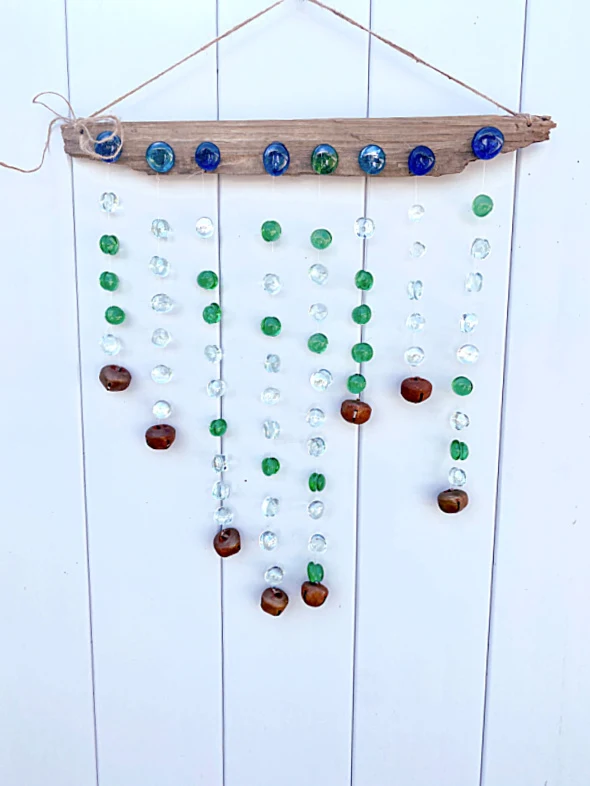 wind chime with glass beads on fence