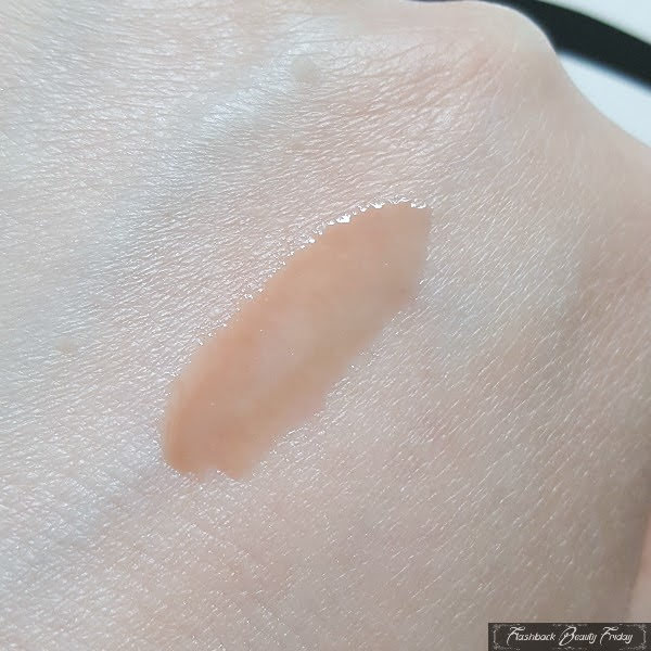 swatch on pale skin of Urban Decay Pocket Rocket Lip Gloss in Kirk