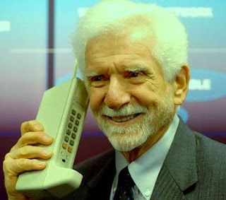 Martin Cooper holding the mobile phone