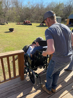 the young strong guys carrying Chris in his chair down the stairs at my sister's house