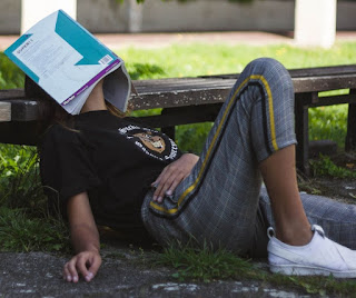 person with book open over face