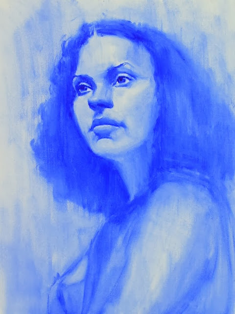 Painting of model's face in blue paint