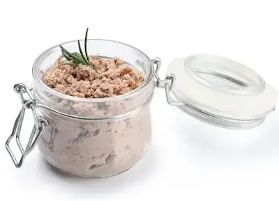 Smooth salmon pate served with toasted bread and herbs