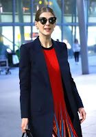 Rosamund Pike in Red Dress at London’s Heathrow Airport