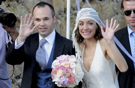 Andrés Iniesta and his wife Anna Ortiz wave to the crowd during their wedding ceremony