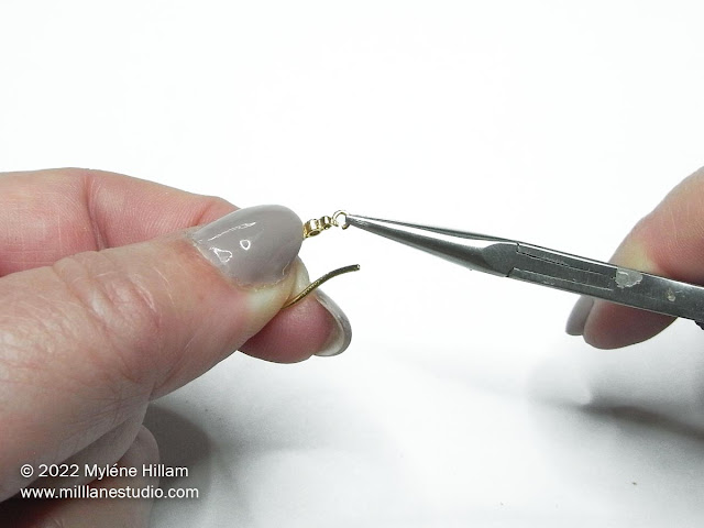 Open the earring loop with chain nose pliers