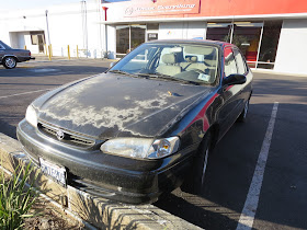Toyota Corolla with oxidized paint before refinishing at Almost Everything Auto Body