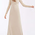 Long satin-back dress with flared skirt at the bottom and small train.