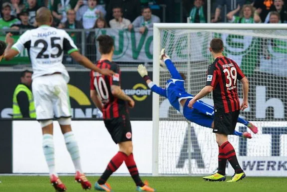 Frankfurt goalkeeper Kevin Trapp is unable to save a goal from Wolfsburg's Naldo