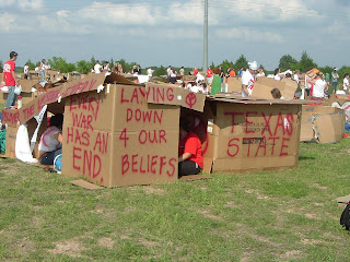 One of the many and various cardboard structures created on Saturday.  This one says in red paint ''Every war has an end.  Laying down 4 our beliefs.  Texas State''