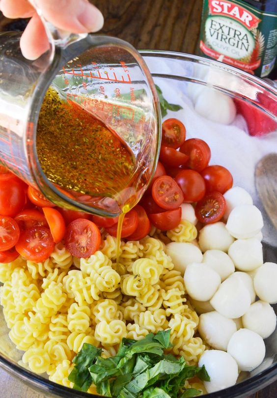 Caprese Pasta Salad Recipe This pasta salad is filled with mozzarella, tomatoes and basil. Tossed with an Italian oil dressing and topped with balsamic glaze.