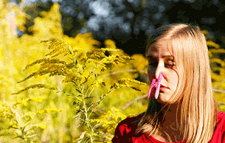 Lady with a close pin on her nose to keep out the pollen