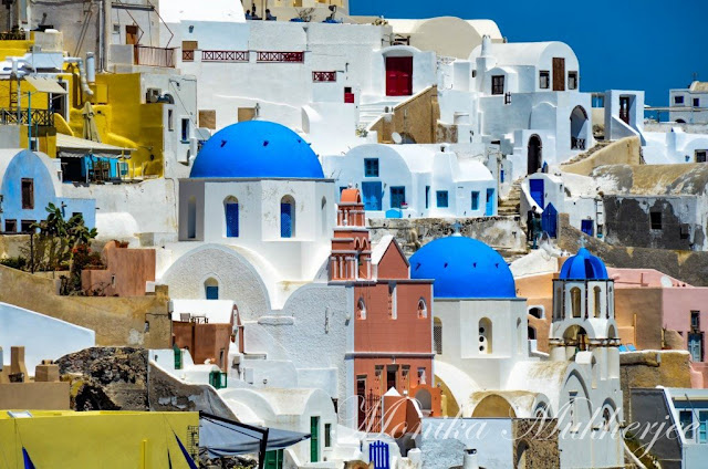 Blue Roofs in Oia Santorini Greece by Monika Mukherjee