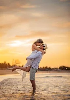 couple adventure - man lifting woman in a romantic way