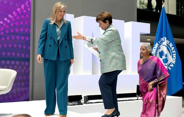 Queen Maxima wore a new blue double-breasted tailored blazer by Dries Van Noten, and blue wide-leg trousers by Dries Van Noten