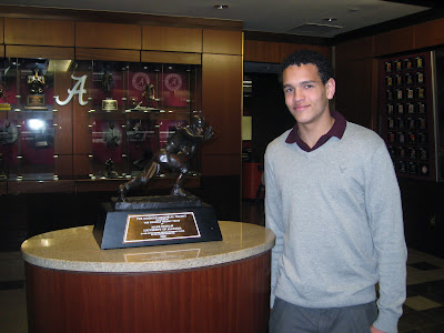 4* WR Derek Kief posing next to the 75th Heisman rewarded to Alabama Running Back Mark Ingram