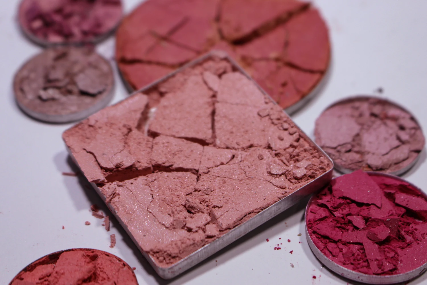 a close-up studio photo of crushed eyeshadows and makeu powders