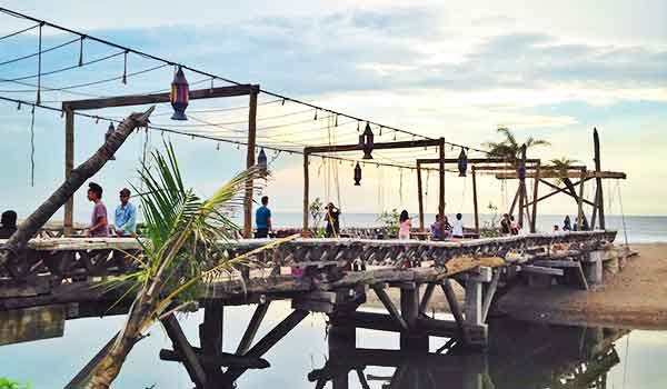 Kayu Putih Beach - Beach With a Backdrop of a Wooden Bridge that Extends Over the Lagoon