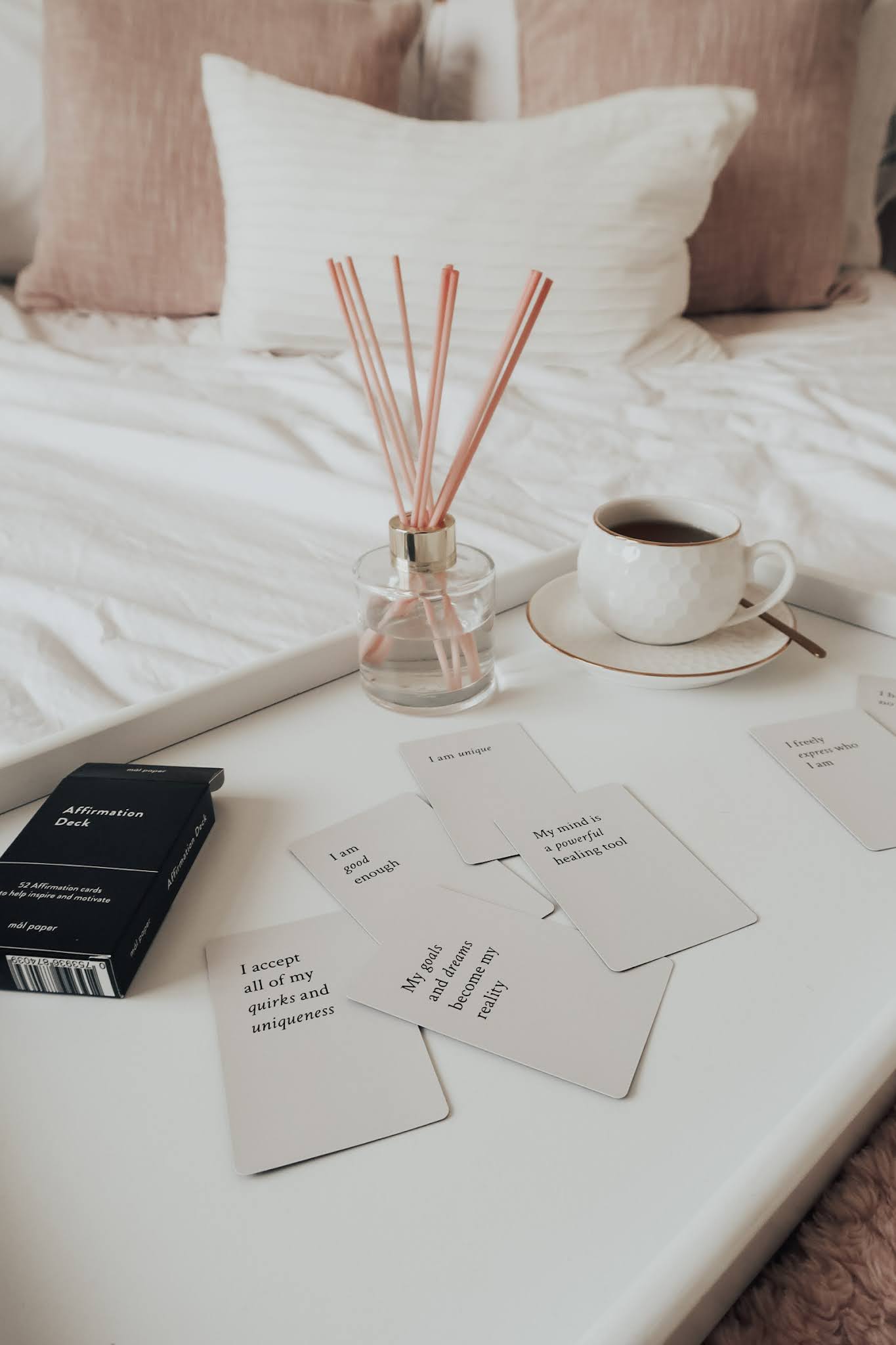 Splayed white affirmation cards on a white tray.