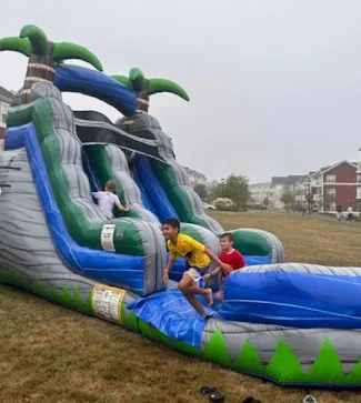 Boys running on outdoor inflatable slide