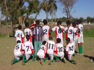 Sandra with Team USA from behind with numbers to help her identify who is who on the field